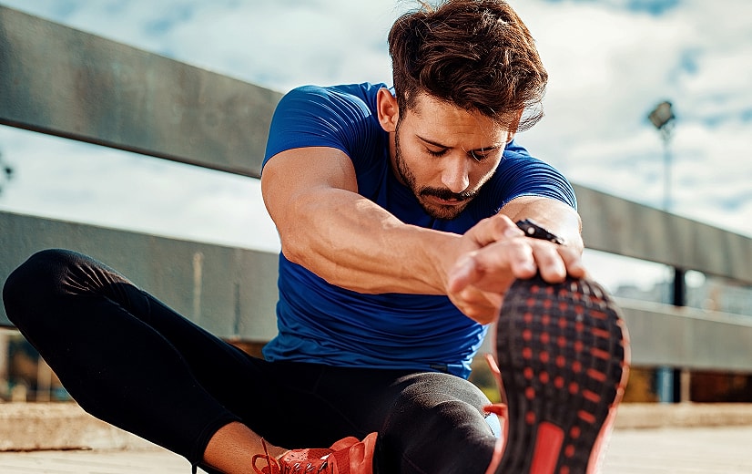 Man stretching before exercising outdoors.