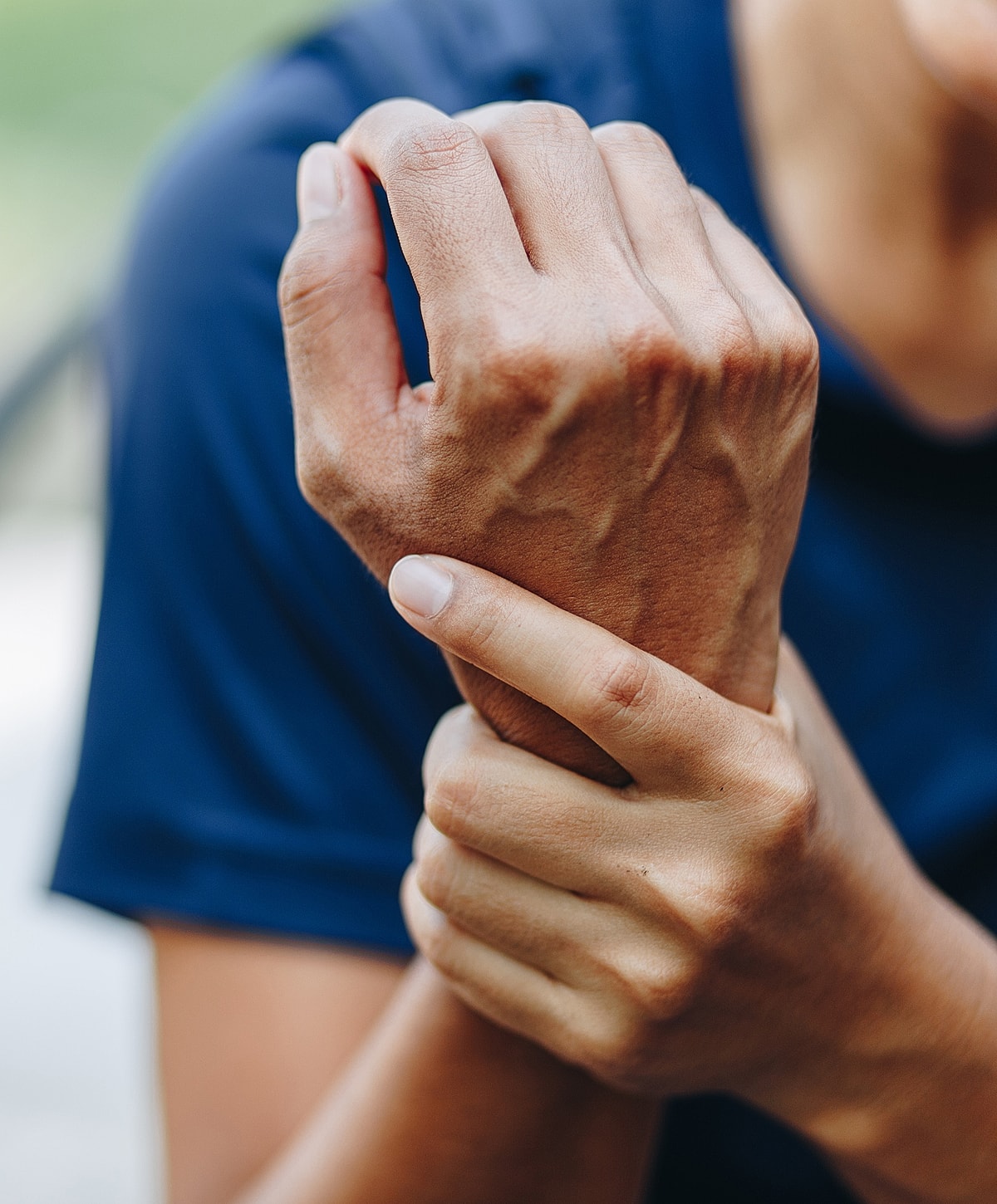 Hands holding wrist in a relaxed position.