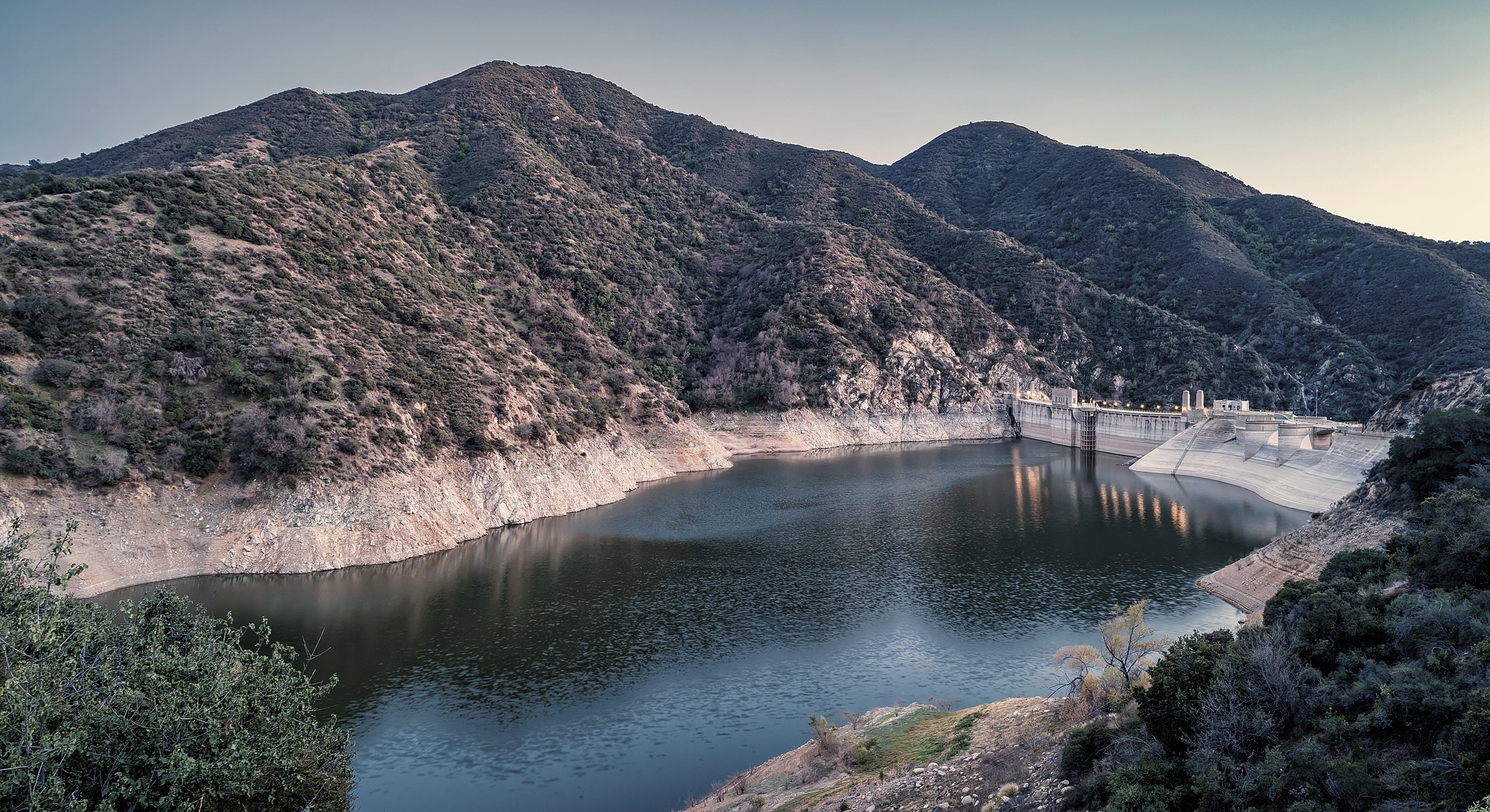 Mountainous landscape with a serene reservoir.