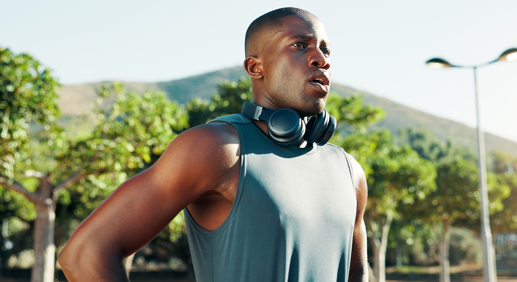 Man exercising outdoors with headphones on.