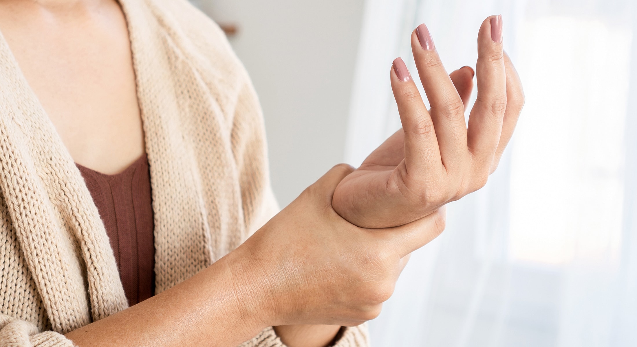 Person holding wrist, perhaps experiencing discomfort.